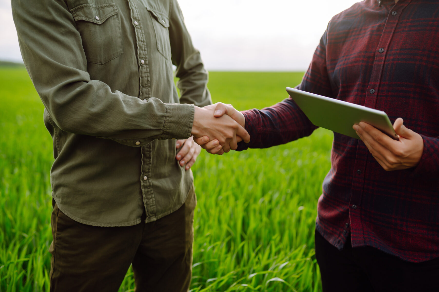 Two farmers making agreement shaking hands